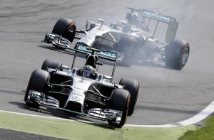 Mercedes Formula One driver Rosberg makes mistake at a corner as his team mate Hamilton drives by during the Italian F1 Grand Prix in Monza